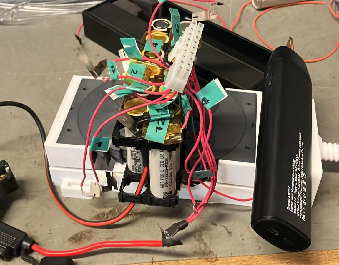 Numbered lithium-ion cells, wiring, and test equipment during battery-pack development